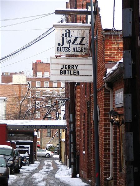 Blues Alley - Rudi Riet from Washington, DC, United States - Blues Alley Jazz Club Such a wonderful old hole-in-the-wall - a place where jazz greats past and present hold command on a regular basis. See a similar photo in sepia <a href="https://www.flickr.com/photos/rudiriet/99527465/">here</a>. •	CC BY-SA 2.0 •	File:Blues Alley side.jpg •	Created: 12 February 2006 Blues Alley side - Blues Alley - Wikipedia  (2/12/2006 - Credits: Rudi Riet from Washington, DC, United States - Blues Alley Jazz Club)